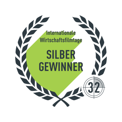 Logo mit Lorbeerkranz und dem Schriftzug "Internationale Wirtschaftsfilmtage Silber Gewinner"